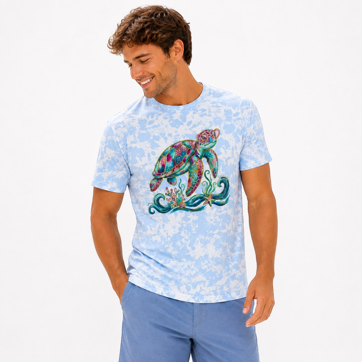 Tea Shirt Shoppe Wholesale light blue tie-dye t-shirt with a colorful graphic of a sea turtle swimming amongst coral and seaweed.