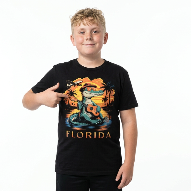 Child wearing a black t-shirt with a graphic design and shorts on a white background