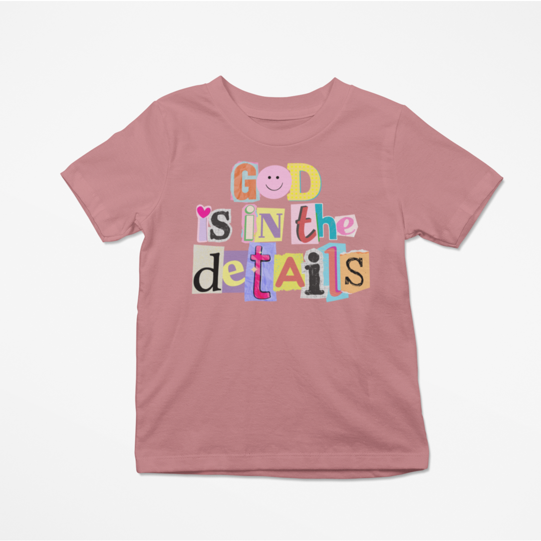 Pink t-shirt with colorful text design on a white background