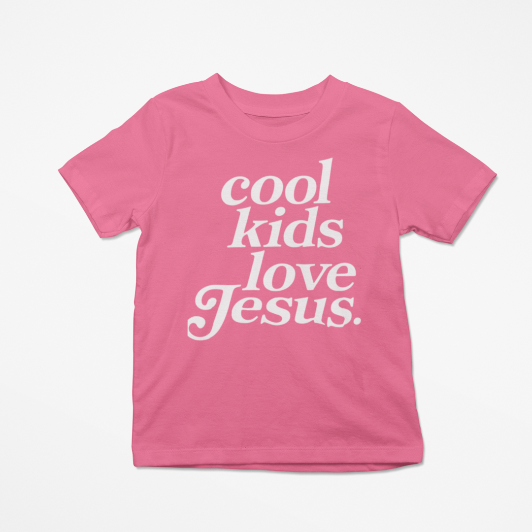 Pink t-shirt with 'cool kids love Jesus' text on a white background