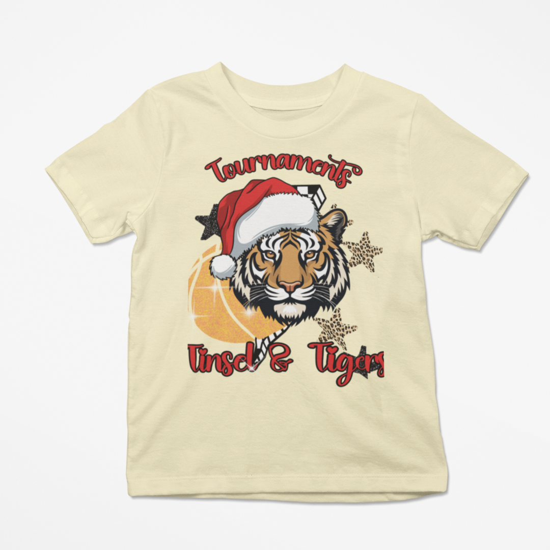 Beige t-shirt with a tiger graphic wearing a Santa hat and text on a white background