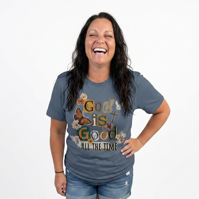 Woman wearing a blue t-shirt with 'God is Good All the Time' text and graphics on a white background