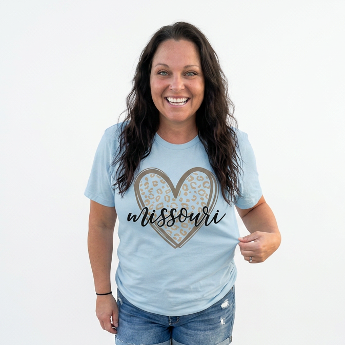 Woman wearing a light blue t-shirt with 'Heart Missouri' design on a white background