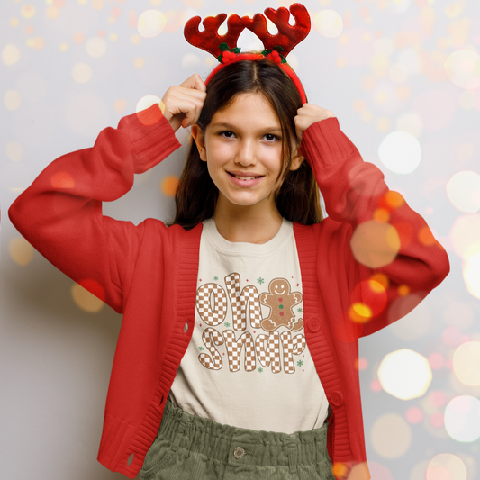Person wearing a red cardigan and reindeer antlers with a festive background