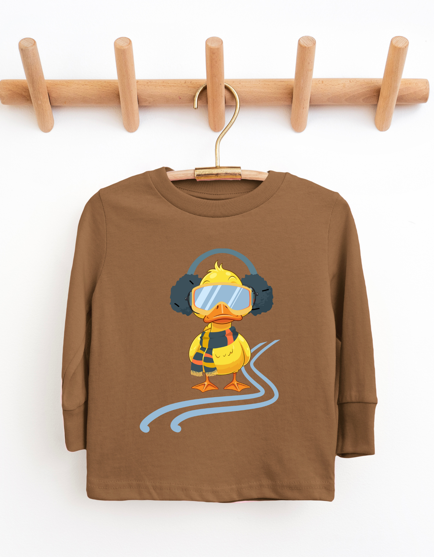 Brown children's long-sleeve shirt with a cartoon duck design on a wooden hanger against a white background.