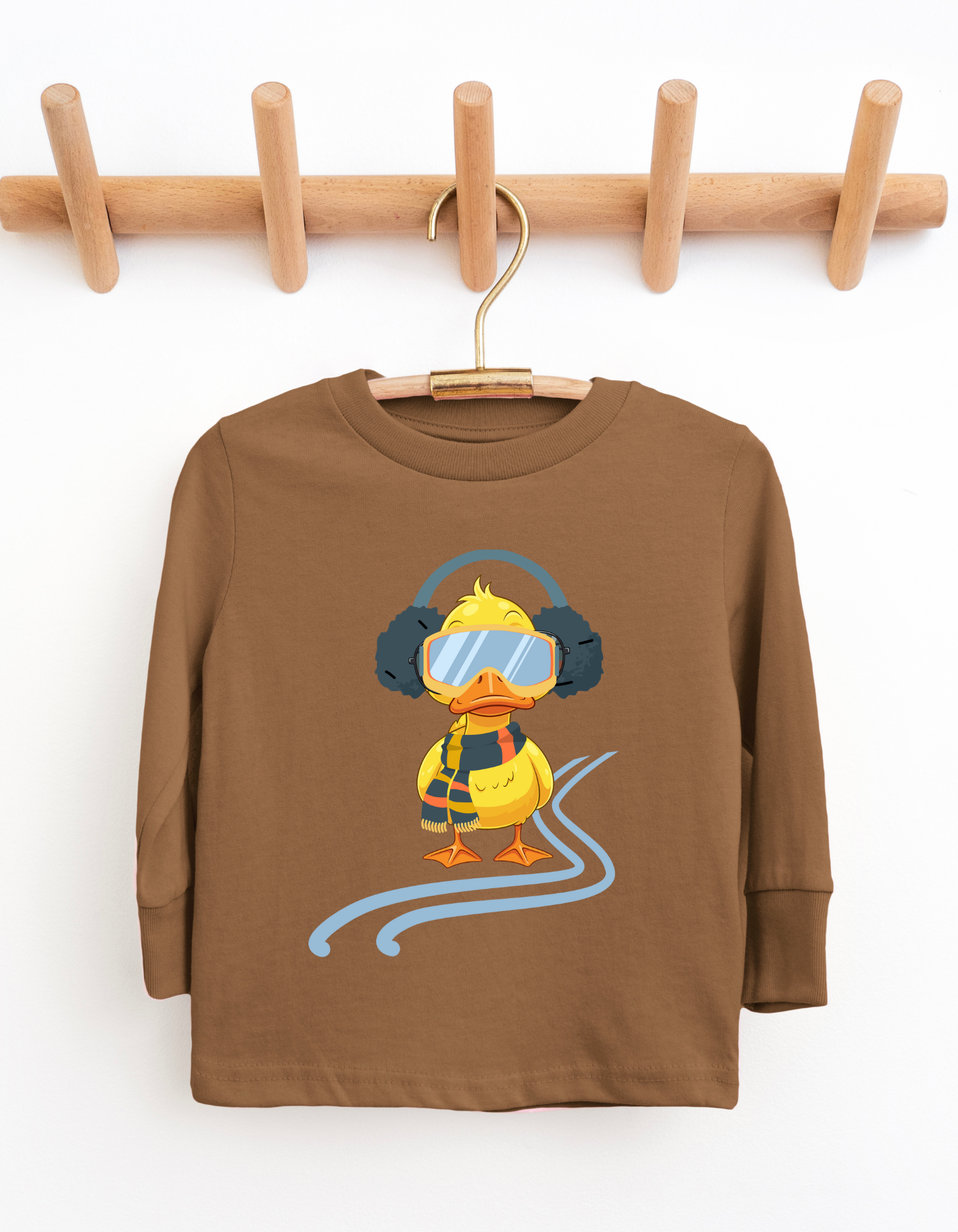 Brown children's long-sleeve shirt with a cartoon duck design on a wooden hanger against a white background.