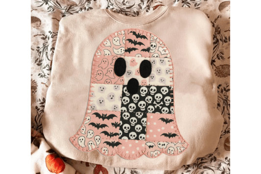 Blush sweatshirt with a Halloween-themed ghost design on a patterned surface