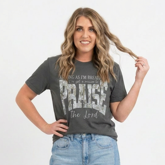 Woman wearing a gray t-shirt with text and blue jeans on a white background