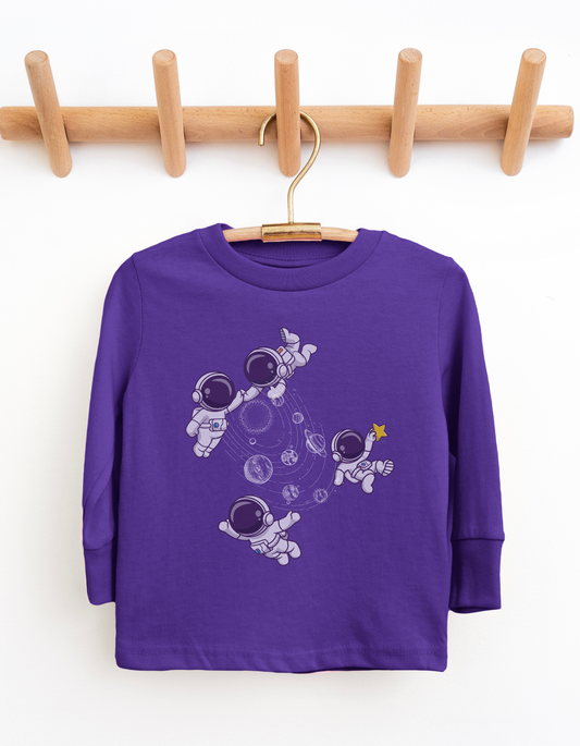 Purple long-sleeve shirt with astronaut design on a wooden hanger against a white background