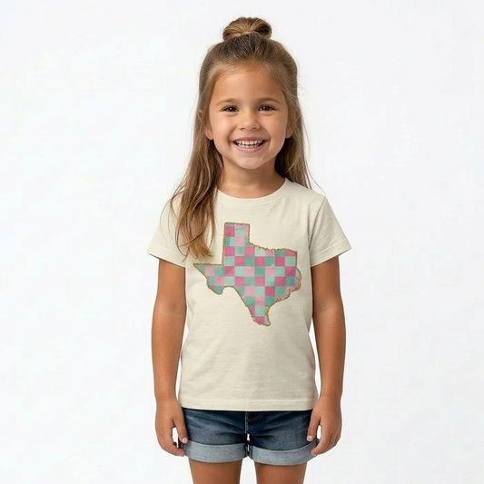 Young girl wearing a t-shirt with a Texas-shaped design on a white background
