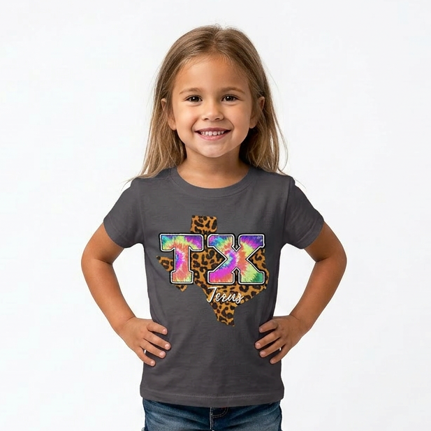 Young girl wearing a gray t-shirt with colorful graphics and text, standing against a white background