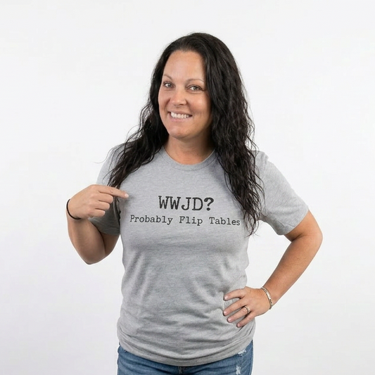 Woman wearing a gray t-shirt with text, standing against a white background