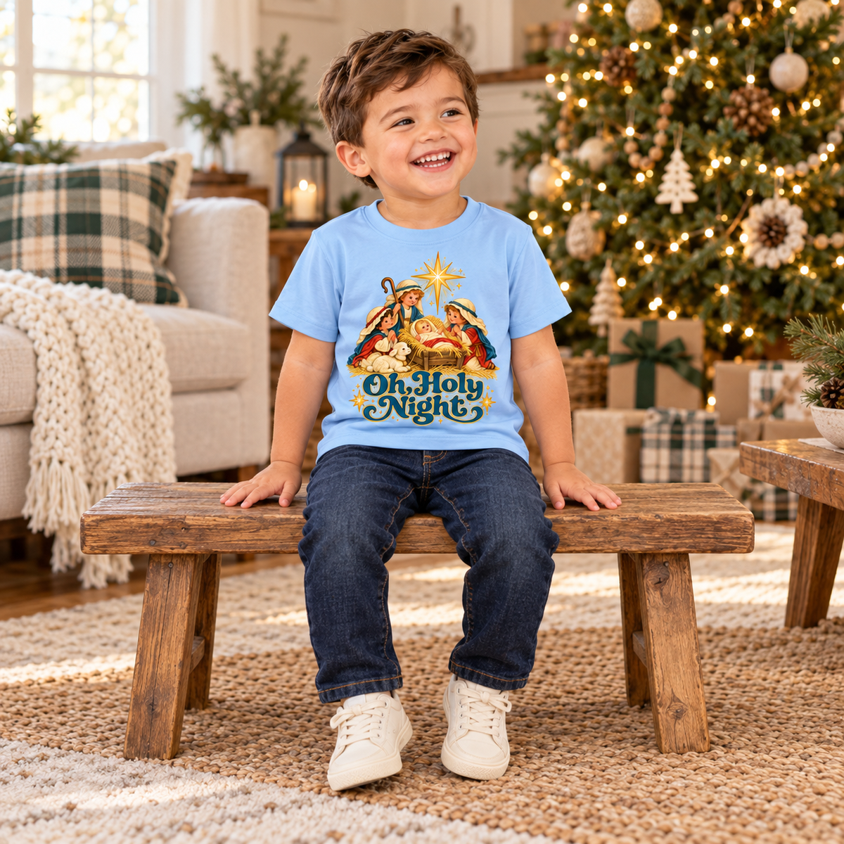 Toddler wearing Oh, Holy Night tee beside a Christmas tree