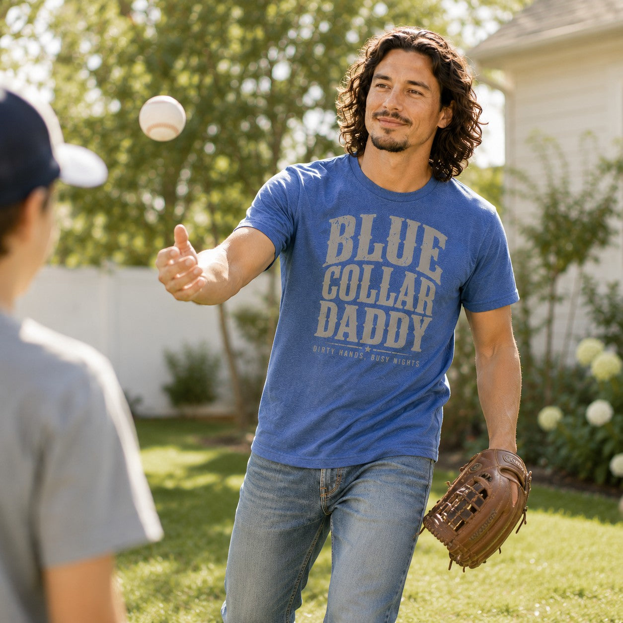 Tea Shirt Shoppe Wholesale blue graphic tee with "BLUE COLLAR DADDY" and "DIRTY HANDS, BUSY NIGHTS" text.
