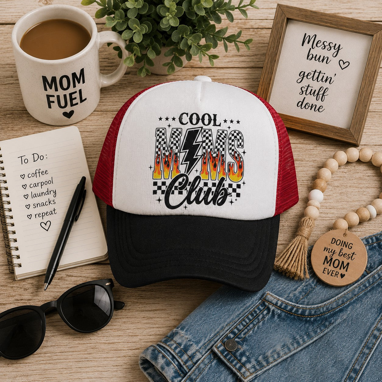 Tea Shirt Shoppe Wholesale trucker hat with 'Cool Moms Club' graphic featuring flames and checkered pattern. White front, red mesh back.
