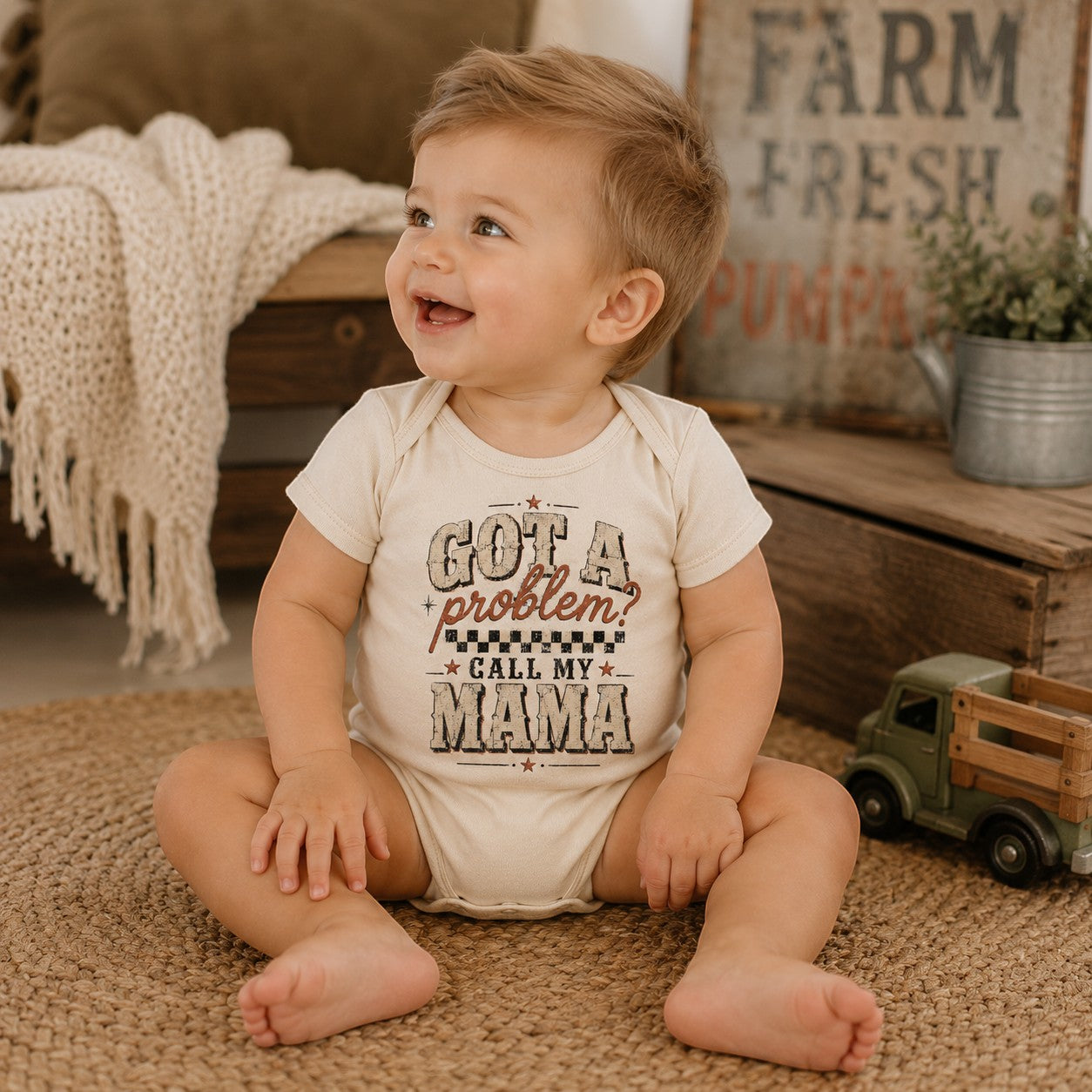 Tea Shirt Shoppe Wholesale cream infant bodysuit with Got a Problem Call My Mama graphic on a smiling baby