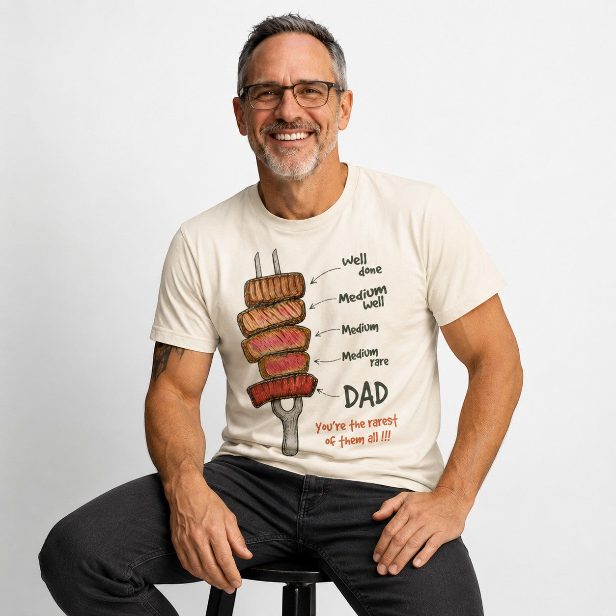 Tea Shirt Shoppe Wholesale cream graphic tee with steak doneness levels pointing to DAD, reading "You're the rarest of them all!!!"