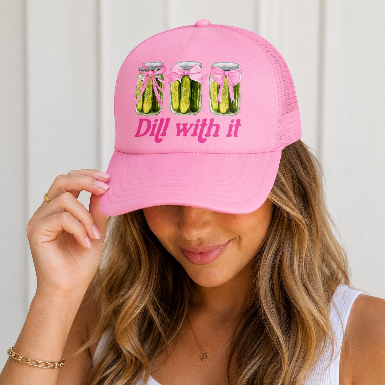 Tea Shirt Shoppe Wholesale pink trucker hat with "Dill With It" text and pickle jars graphic. Mesh back for breathability.