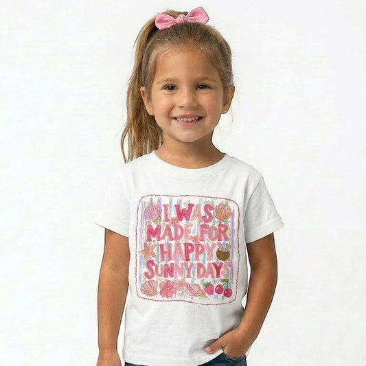 Tea Shirt Shoppe Wholesale white cotton graphic t-shirt with "I Was Made For Happy Sunny Days" text, seashells, starfish, flowers, and cherries.
