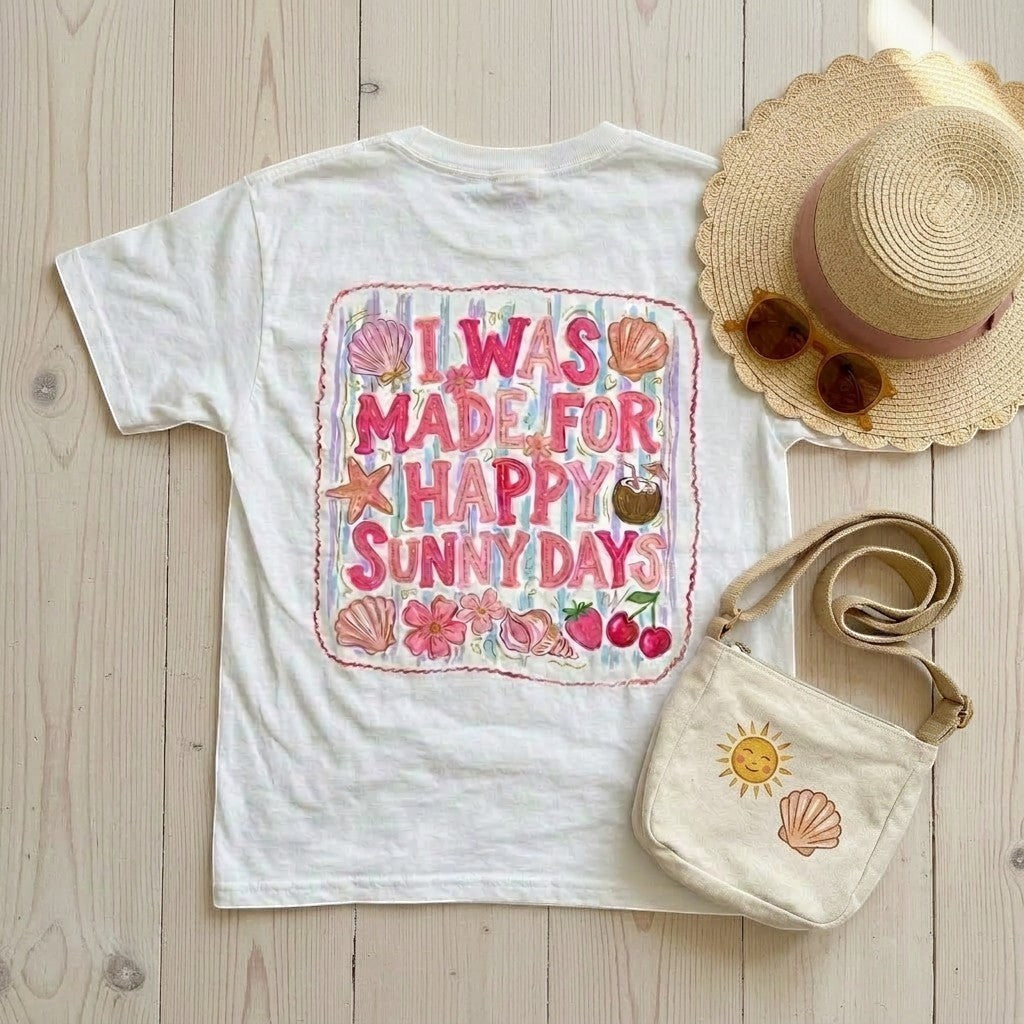 Tea Shirt Shoppe Wholesale white 100% cotton graphic tee with "I Was Made For Happy Sunny Days" DTF print, featuring shells, starfish, flowers, and fruit.