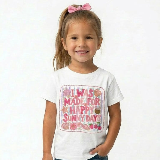 Tea Shirt Shoppe Wholesale white cotton graphic t-shirt with "I Was Made For Happy Sunny Days" text, seashells, starfish, flowers, and cherries.