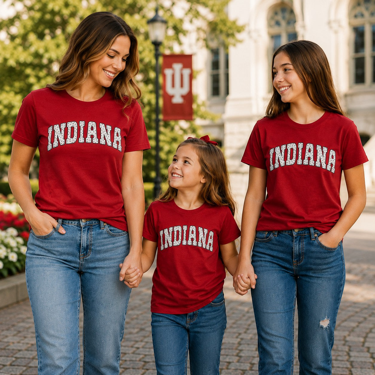 Tea Shirt Shoppe Wholesale maroon Indiana collegiate t-shirts with arched polka dot graphic worn by a family outdoors.
