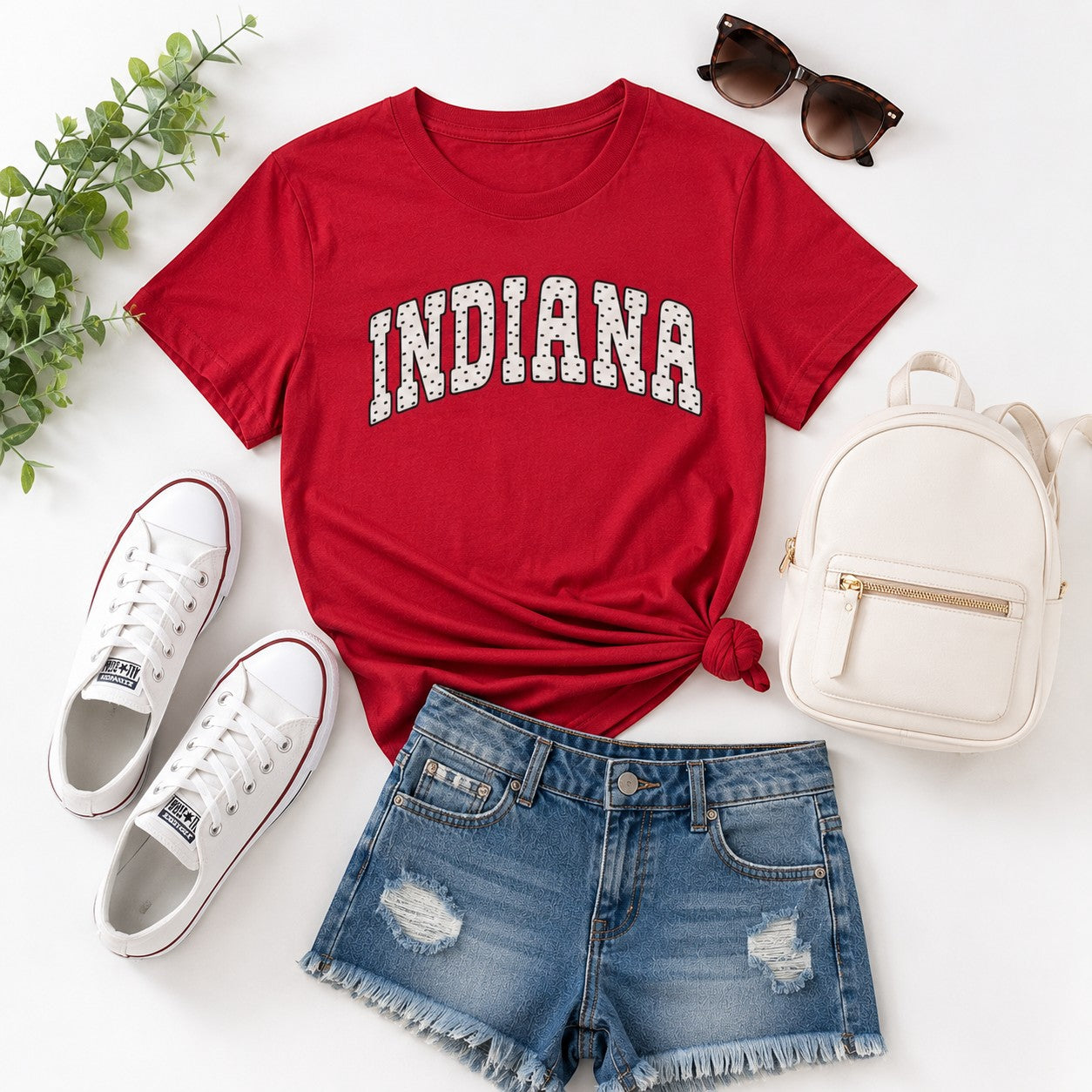 Tea Shirt Shoppe Wholesale red Indiana collegiate graphic cotton t-shirt styled with denim shorts and white sneakers.
