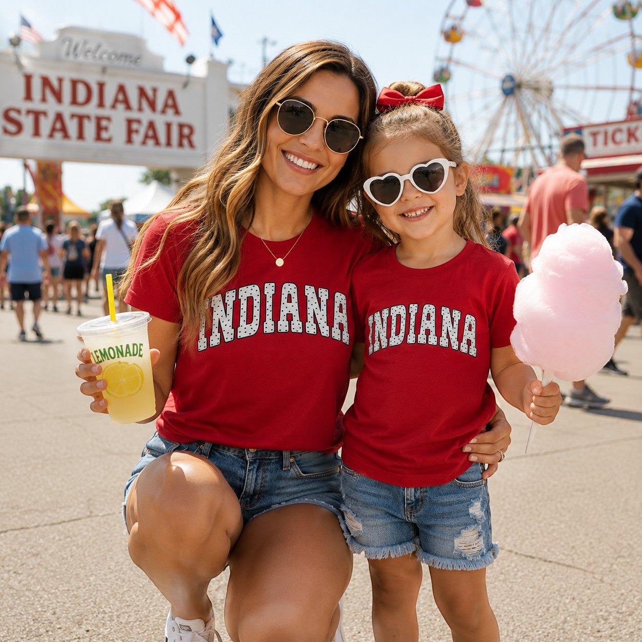 Tea Shirt Shoppe Wholesale red Indiana collegiate graphic t-shirt worn by a mother and daughter at the state fair.