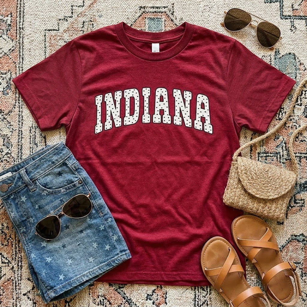 Tea Shirt Shoppe Wholesale maroon cotton blend t-shirt with distressed "INDIANA" graphic in white polka dots.