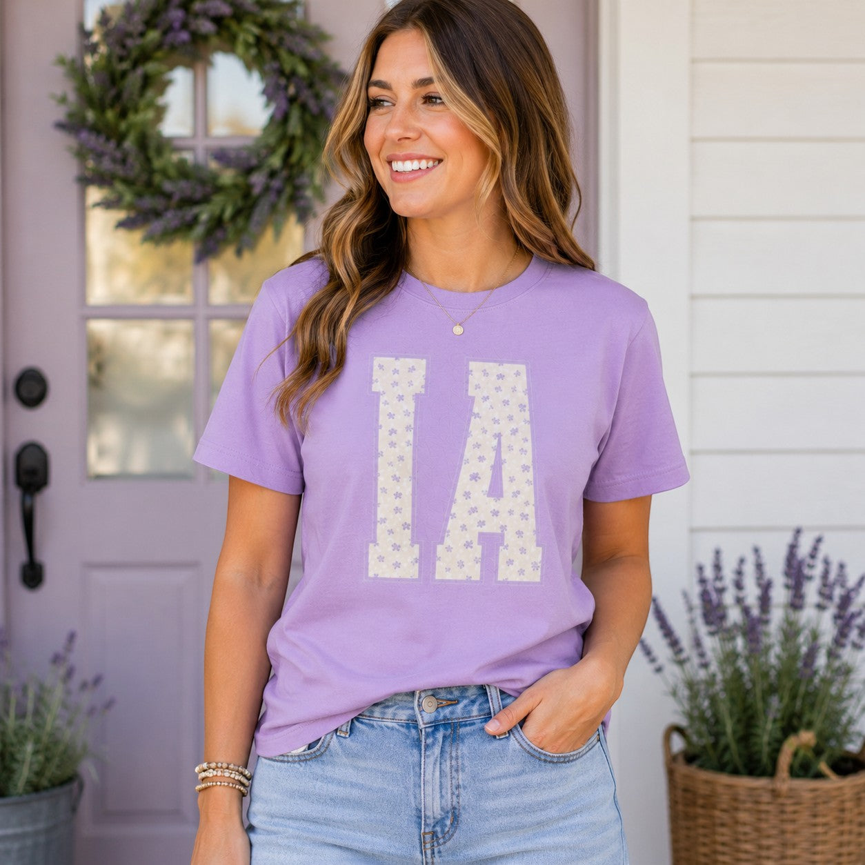 Woman wearing a Tea Shirt Shoppe Wholesale lavender cotton t-shirt with a floral IA graphic print.
