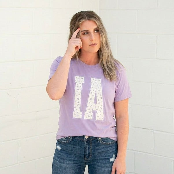 Tea Shirt Shoppe Wholesale lavender cotton graphic tee with floral IA print. Crew neck, short sleeves.