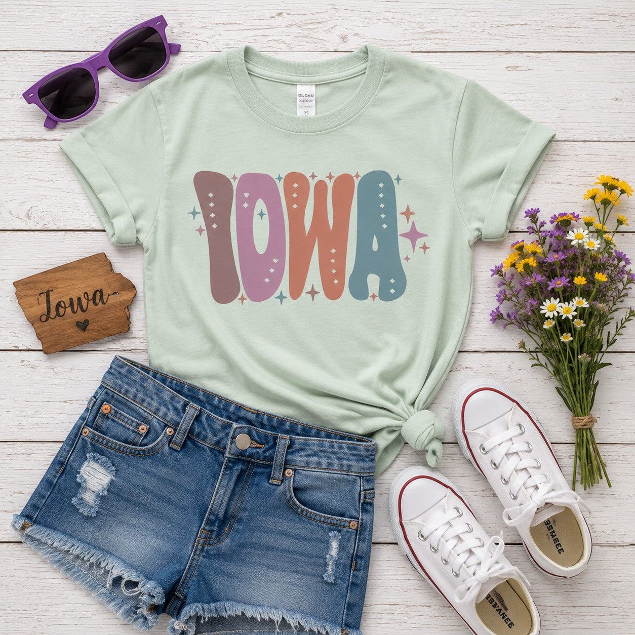 Tea Shirt Shoppe Wholesale mint green youth graphic tee with retro Iowa lettering, star accents, and casual styling.