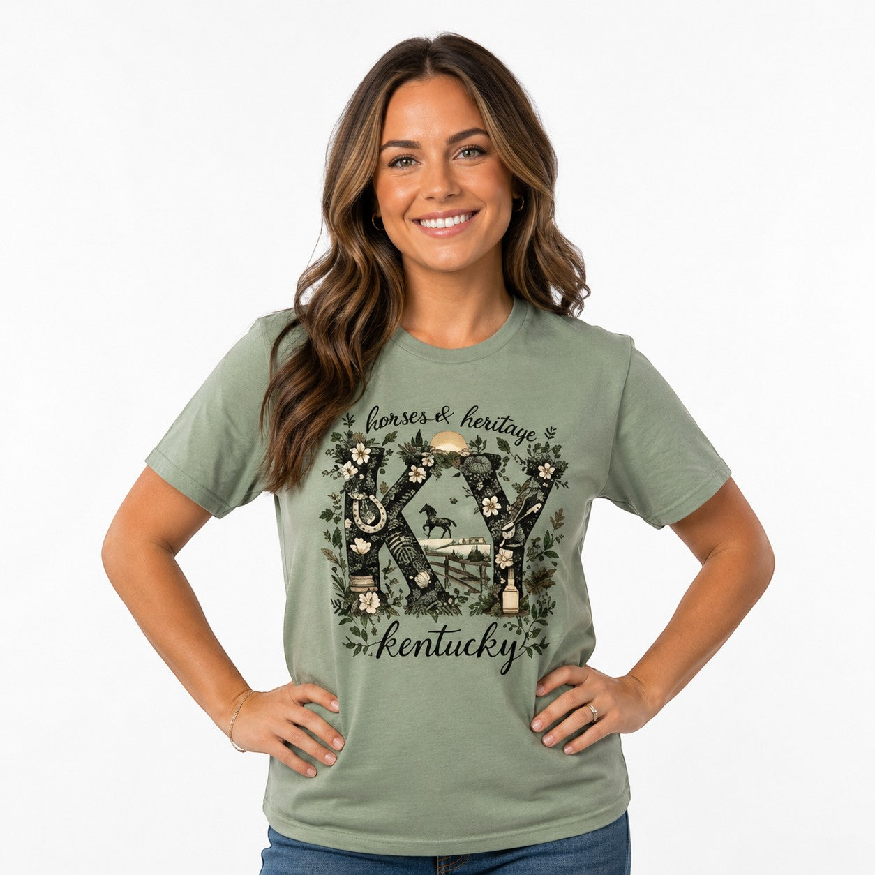 Woman wearing a sage green Tea Shirt Shoppe Wholesale graphic tee with Kentucky horse and heritage floral design.