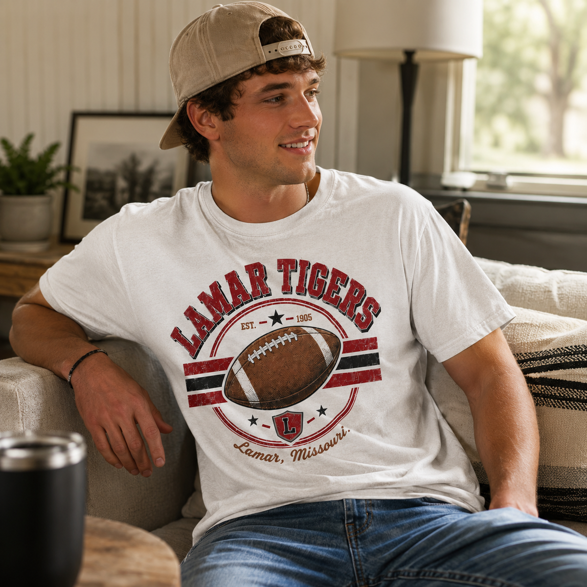 Tea Shirt Shoppe Wholesale Comfort Colors white graphic tee featuring a Lamar Tigers football design on a man