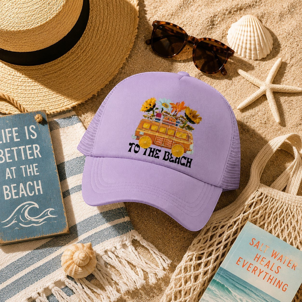 Tea Shirt Shoppe Wholesale lavender trucker hat with "To The Beach" graphic of a retro van filled with flowers.