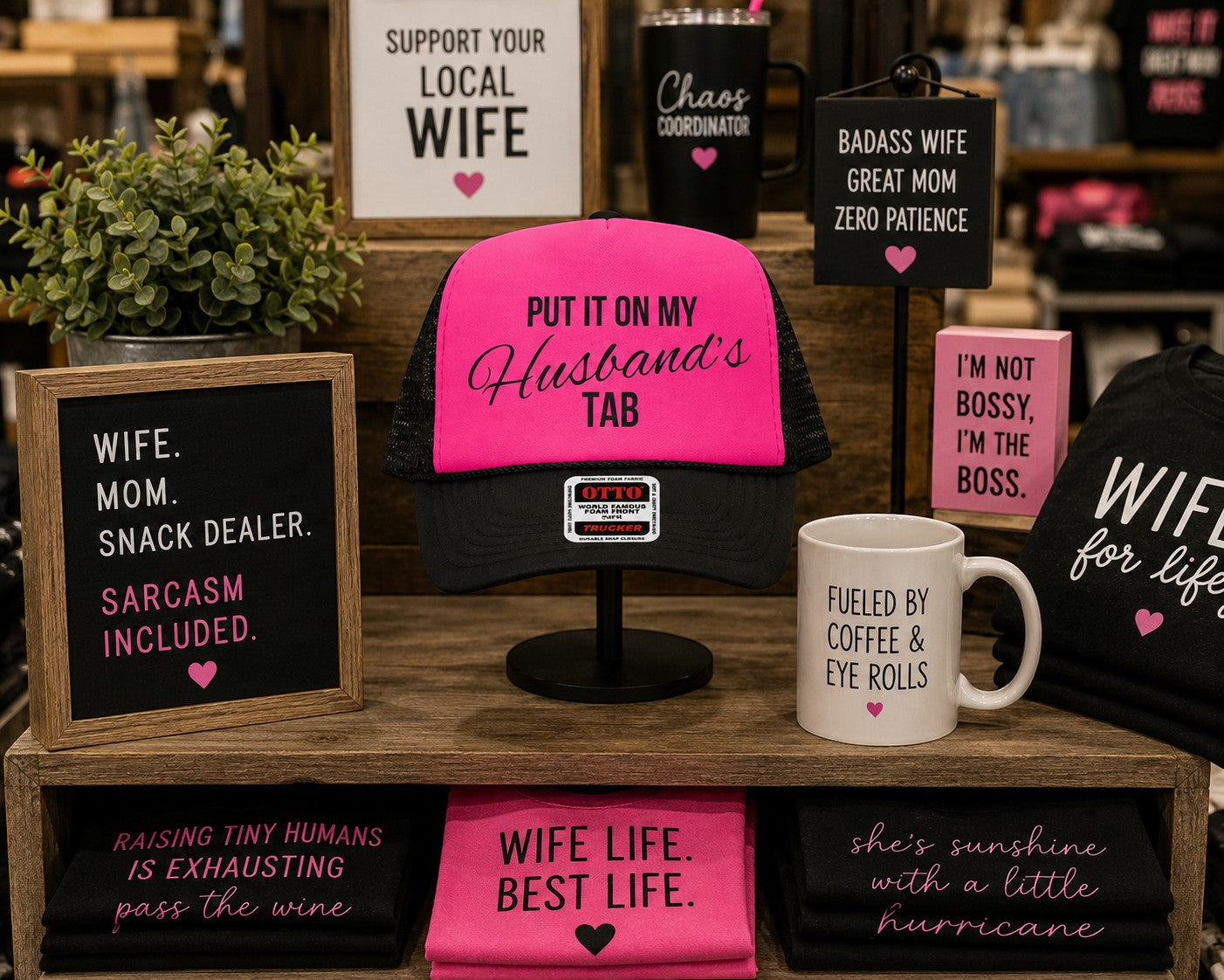 Tea Shirt Shoppe Wholesale neon pink and black trucker hat with Put It On My Husband's Tab graphic on foam front.