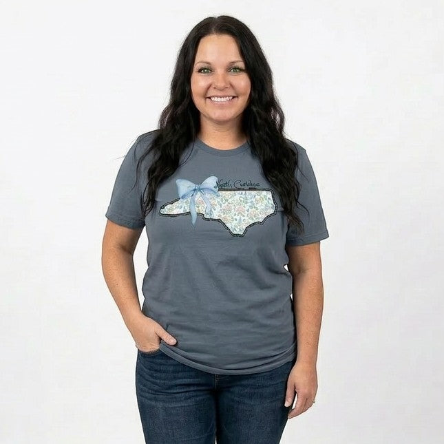 Tea Shirt Shoppe Wholesale grey t-shirt with North Carolina outline filled with floral pattern and blue bow.