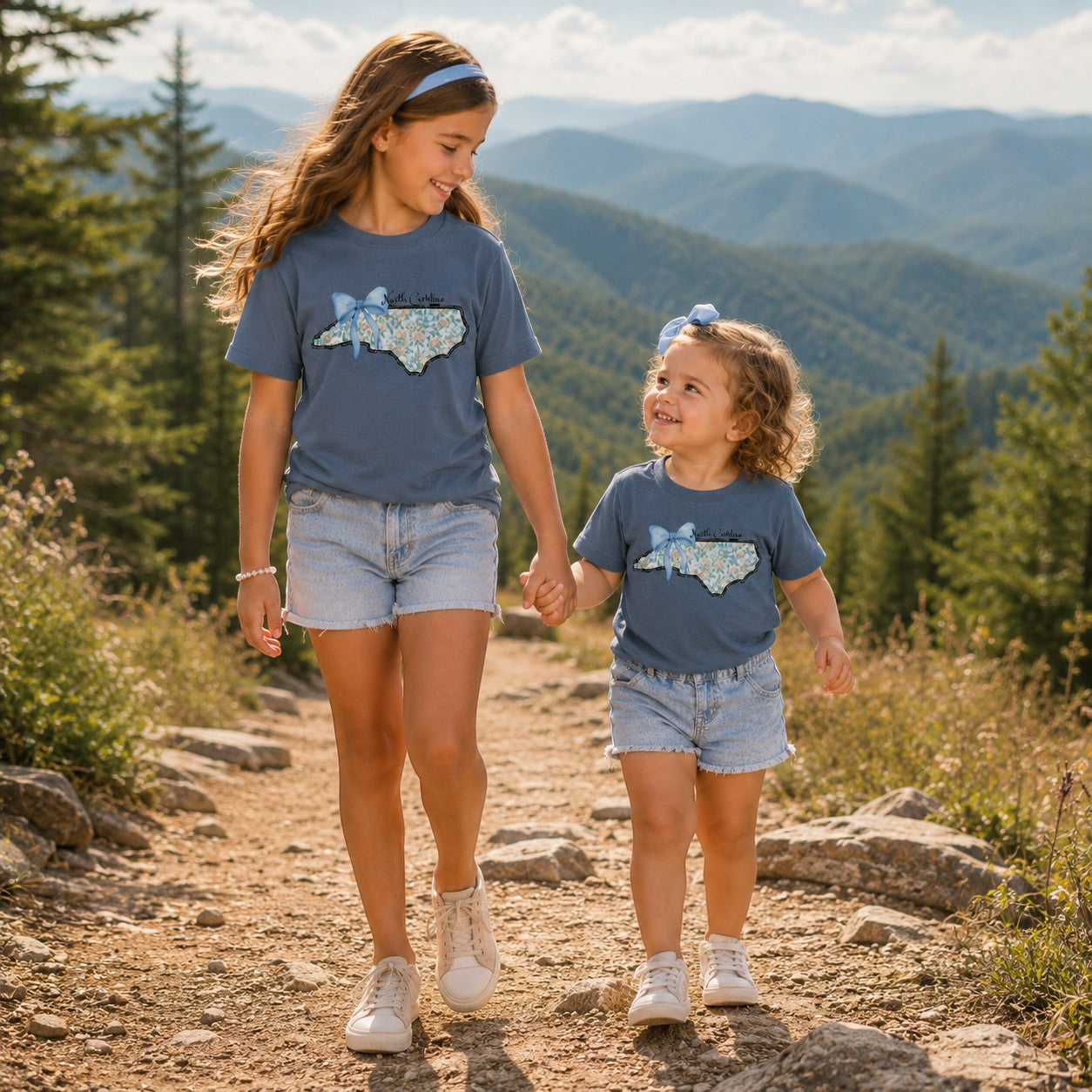 Tea Shirt Shoppe Wholesale indigo cotton graphic t-shirts with floral North Carolina state print on a girl and toddler.