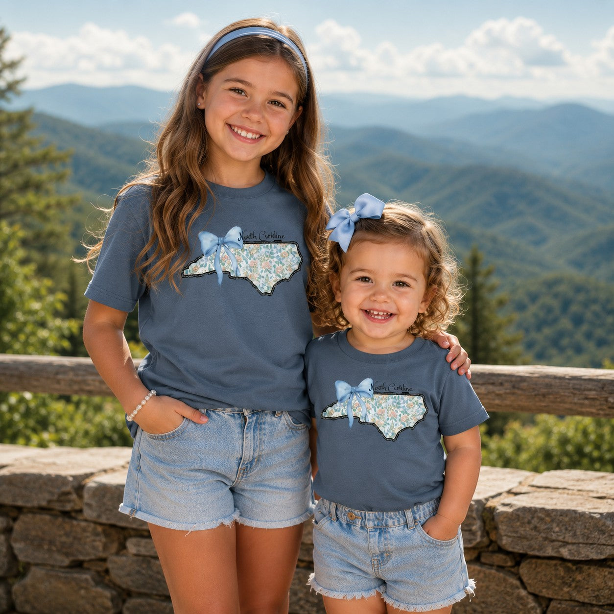 Tea Shirt Shoppe Wholesale indigo cotton t-shirts with floral North Carolina state graphic and blue bow for kids