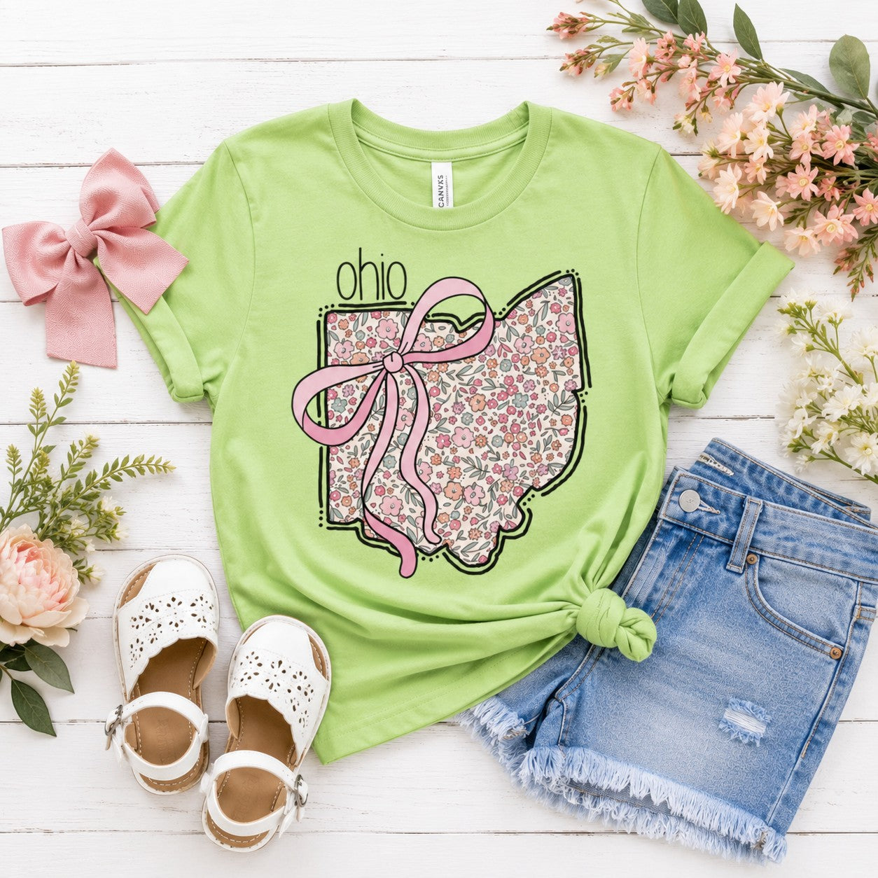 Tea Shirt Shoppe Wholesale light green t-shirt with floral Ohio state outline graphic and pink bow detail.