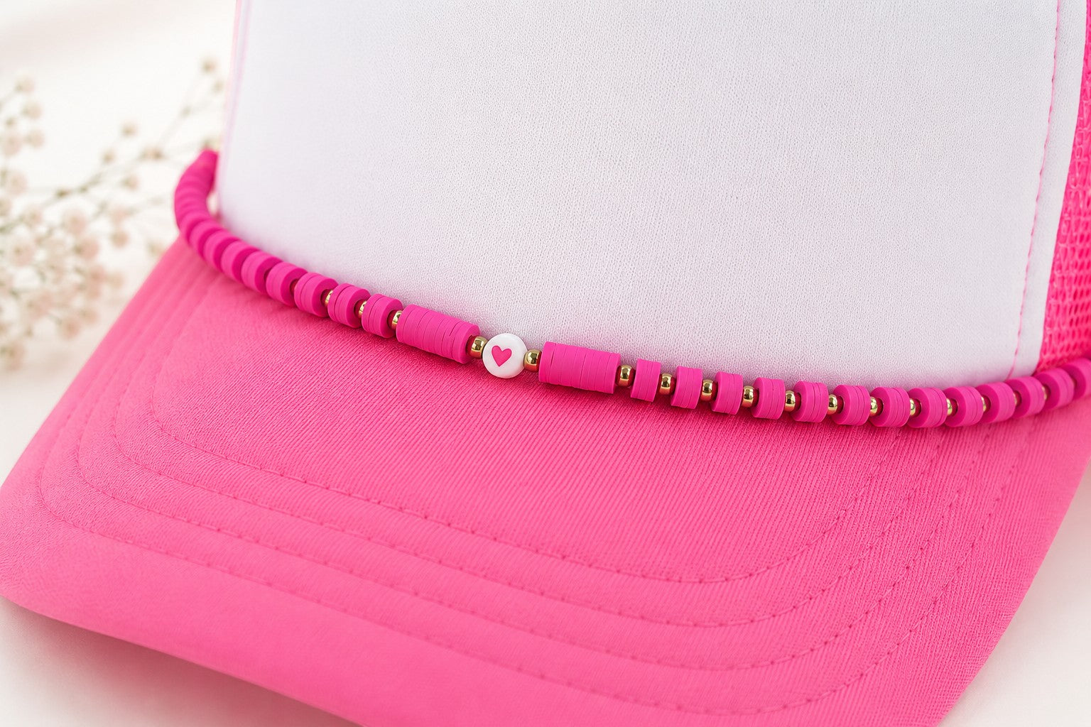 Tea Shirt Shoppe Wholesale pink clay beaded hat chain with metallic spacers and a heart charm on a white trucker hat