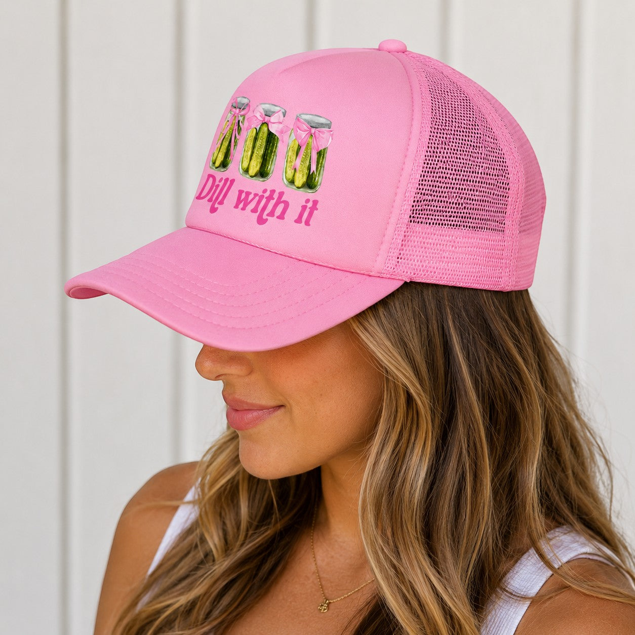 Tea Shirt Shoppe Wholesale pink trucker hat with "Dill With It" pickle jar graphic and mesh back.
