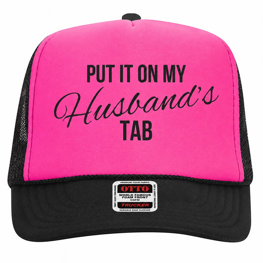 Tea Shirt Shoppe Wholesale neon pink foam trucker hat with black mesh back and Put It On My Husbands Tab graphic.