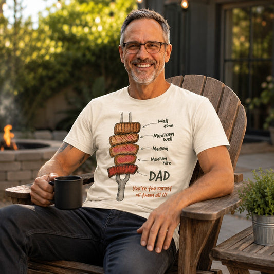 Tea Shirt Shoppe Wholesale cream cotton graphic tee featuring a steak doneness chart and Dad humor on a smiling man.