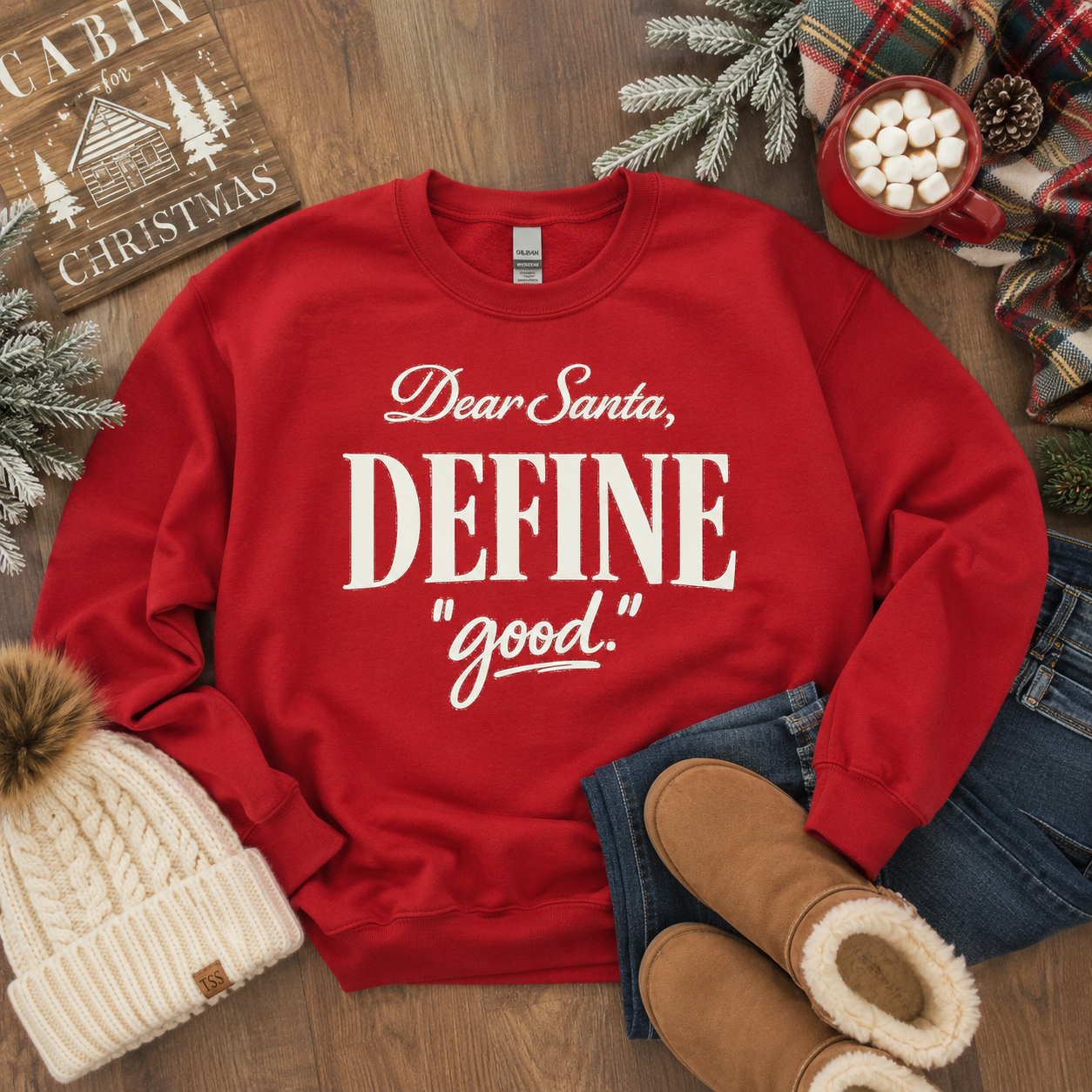 Tea Shirt Shoppe Wholesale red Christmas crewneck sweatshirt with Dear Santa Define Good graphic print on wood table