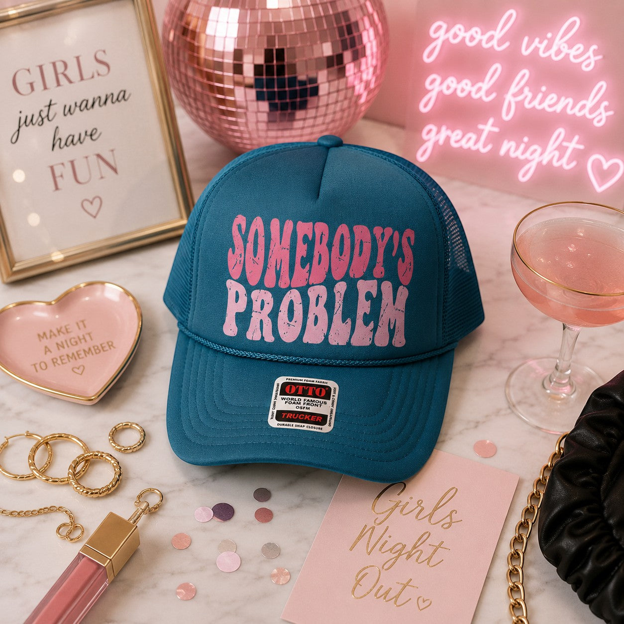 Tea Shirt Shoppe Wholesale teal trucker hat with pink distressed Somebody's Problem graphic and mesh back.
