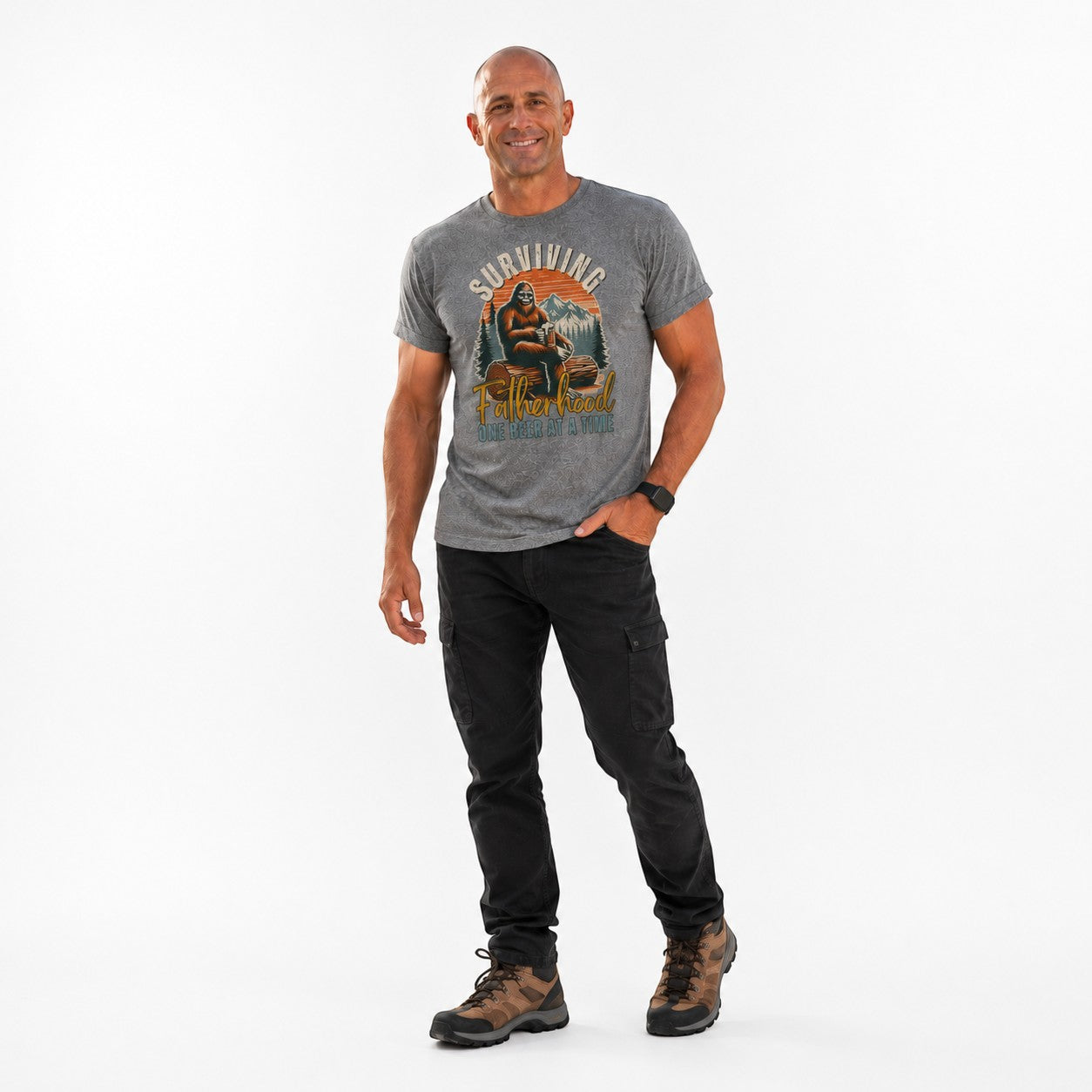 Tea Shirt Shoppe Wholesale grey graphic tee with Bigfoot and mountains, "Surviving Fatherhood One Beer At A Time" text.