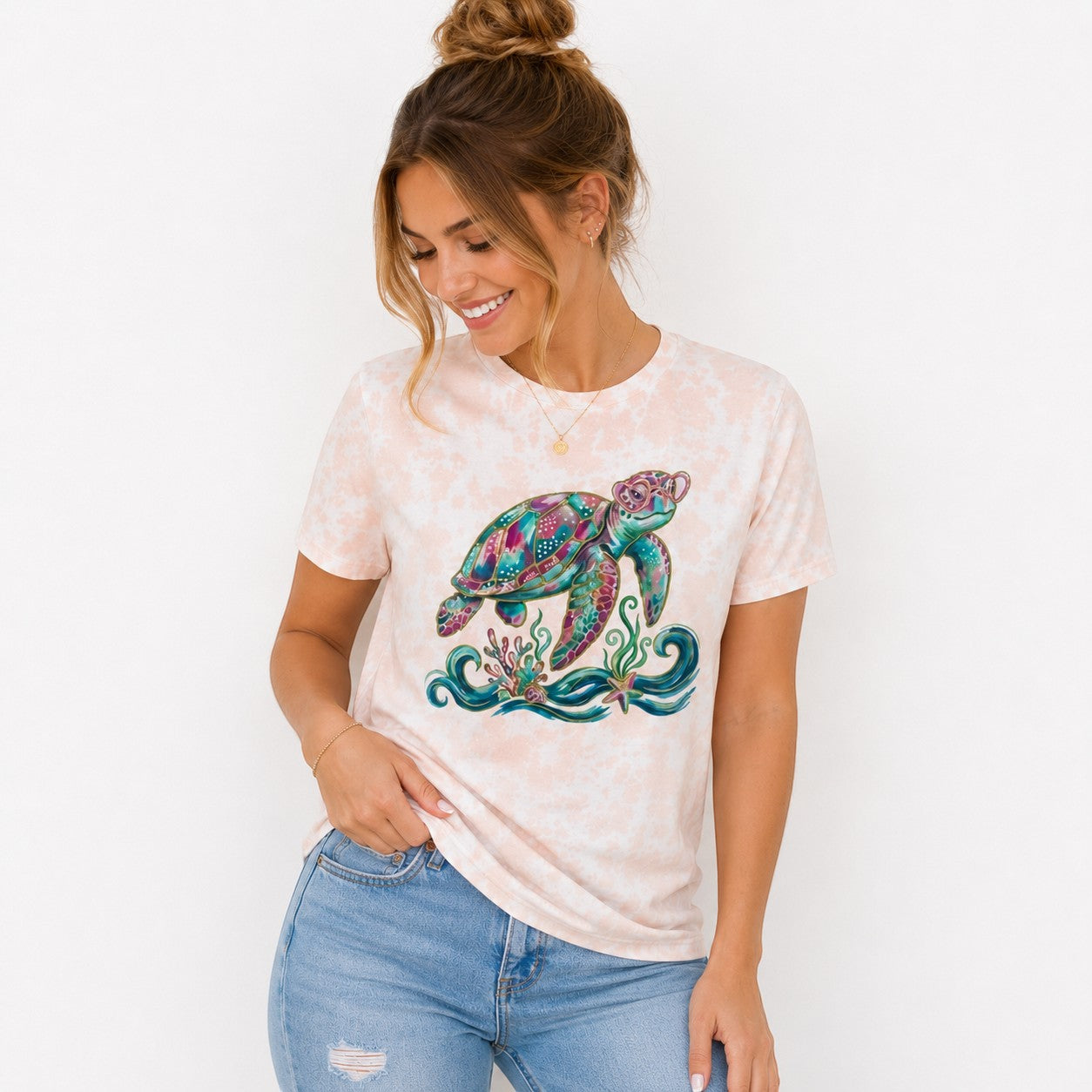 Tea Shirt Shoppe Wholesale peach tie-dye t-shirt with a colorful graphic sea turtle and coral.